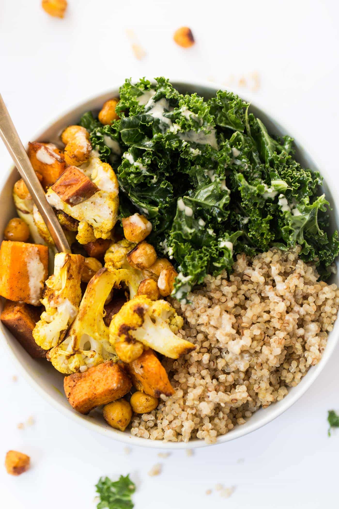 curried roasted vegetable quinoa bowl recipe with creamy tahini dressing