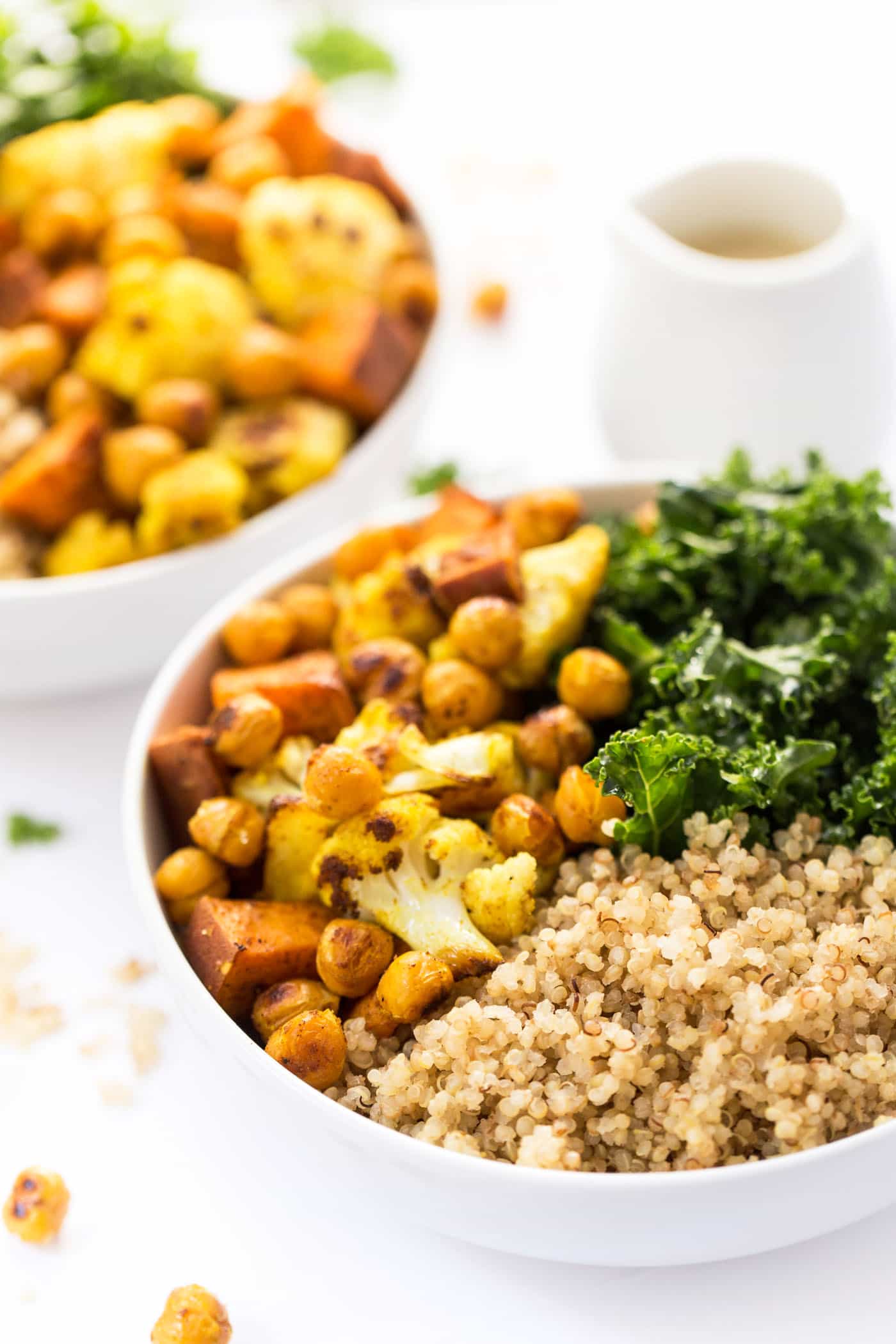 Curry Roasted Vegetable Quinoa bowls with cauliflower, sweet potatoes, chickpeas, kale and a creamy tahini dressing!