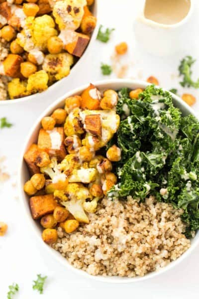 Curry Roasted Vegetable Quinoa bowls with cauliflower, sweet potatoes, chickpeas, kale and a creamy tahini dressing!