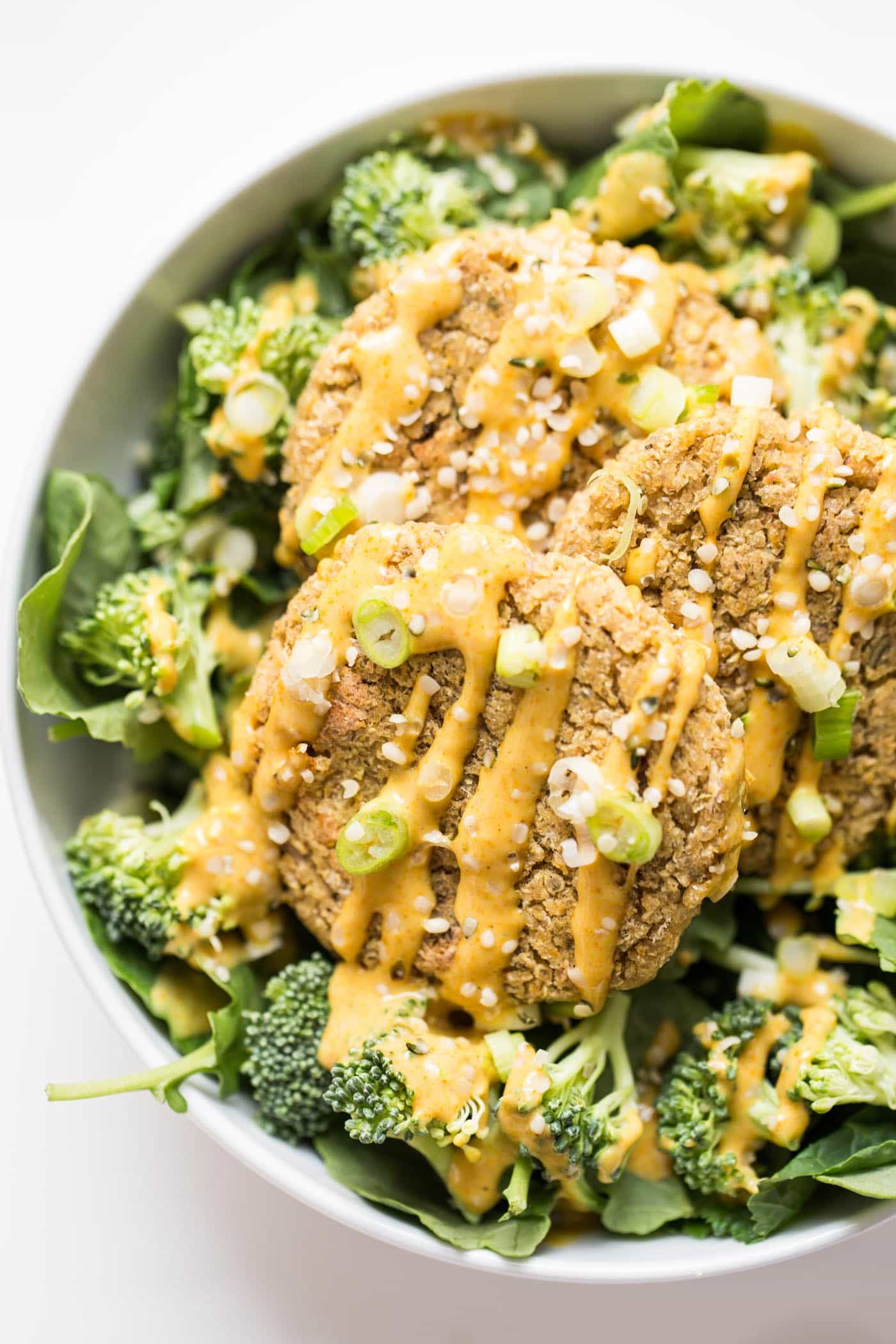 Simple Vegan Quinoa Burgers dressed in a dreamy turmeric-tahini sauce!