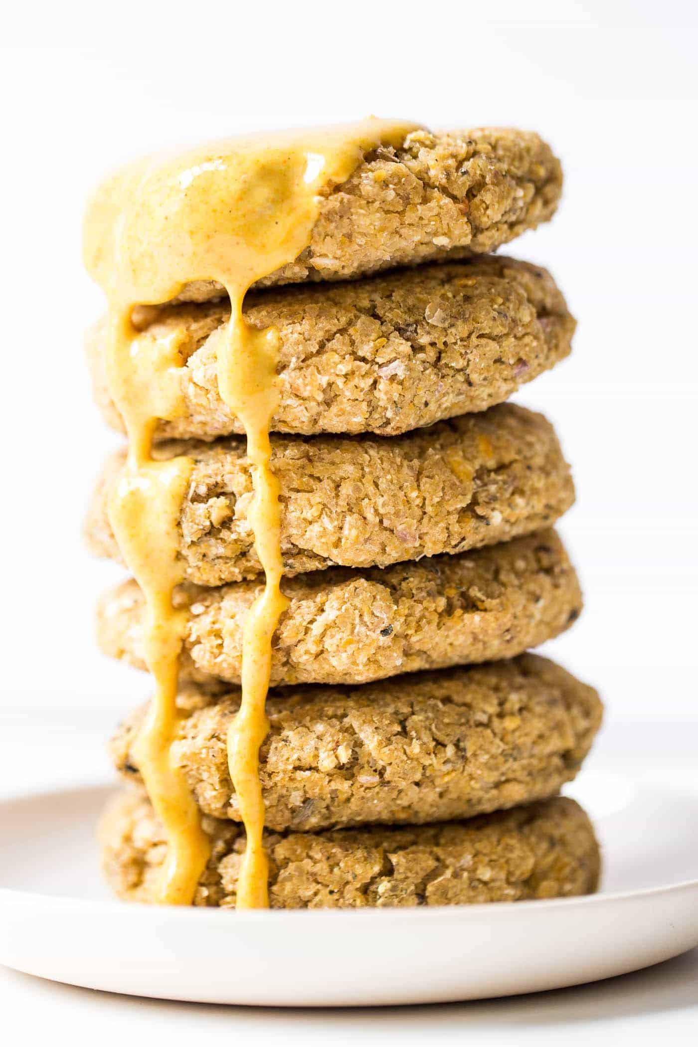 Simple Vegan Quinoa Burgers dressed in a dreamy turmeric-tahini sauce!