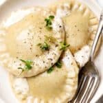 Homemade butternut-spinach ravioli on a serving plate.