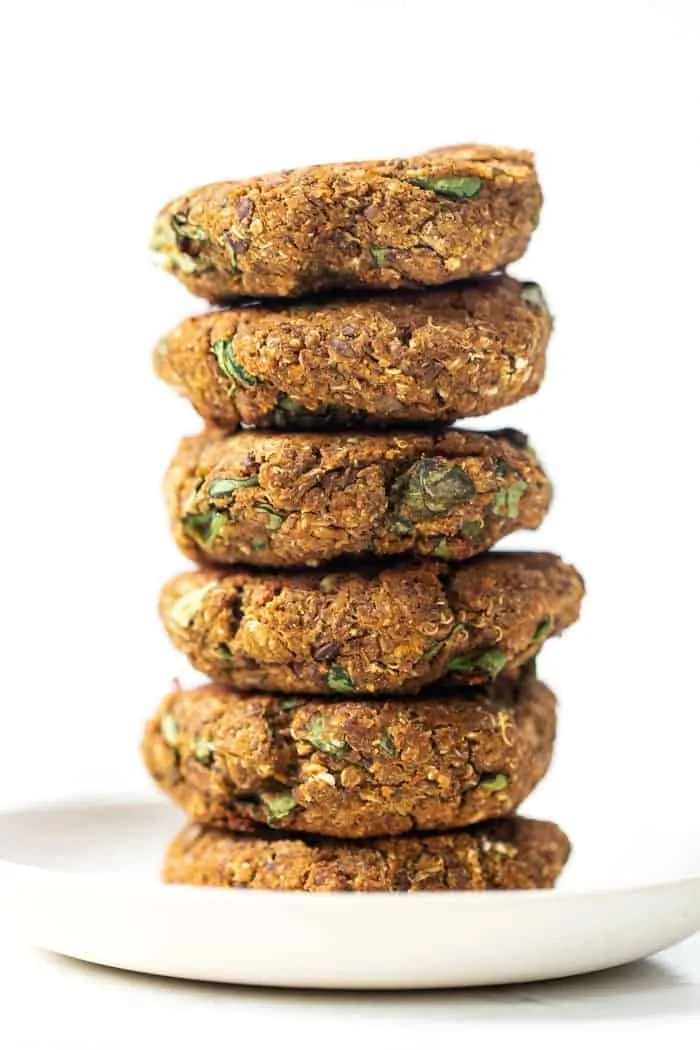 A stack of butternut squash lentil patties on a white plate.