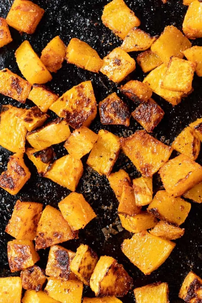 Overhead view of roasted butternut squash on a baking sheet.