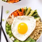 This simple Quinoa Bibimbap is made with steamed veggies and topped with a fried egg for an easy, delicious and meatless meal!