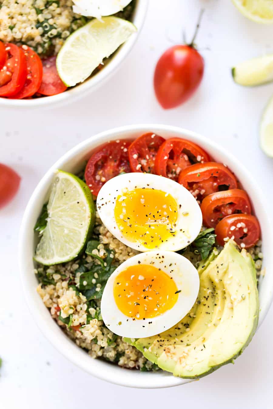 A mexican inspired Quinoa Breakfast Bowl with tomato, avocado and soft boil eggs!