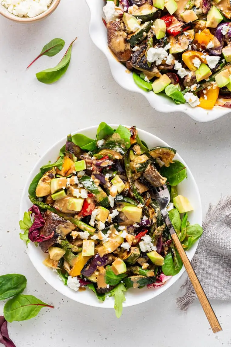 overhead of a serving of grilled vegetable salad with tahini dressing
