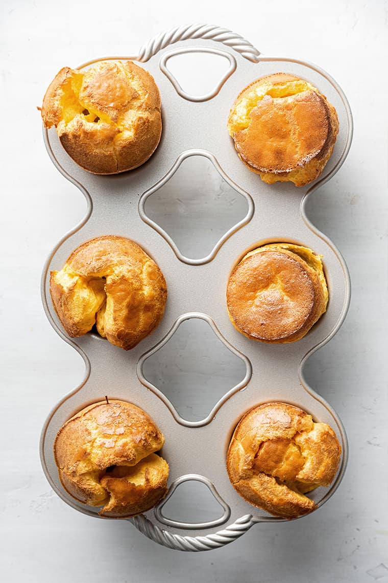 Overhead view of a six-popover pan, full of baked popovers