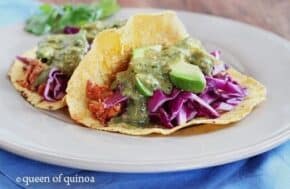 Chicken taco with avocado and onion slices.