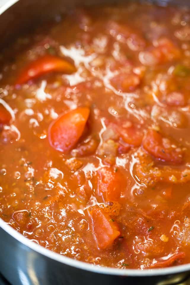 This easy and healthy roasted red pepper soup recipe has fresh tomatoes, quinoa, and lots of spices, and only takes an hour to make. Unblended red pepper and tomato soup simmering with chunks of tomatoes