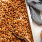 Tray of chili roasted pumpkin seeds with a spoon