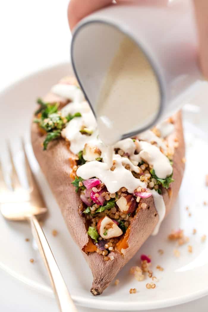 tahini sauce on top of sweet potatoes