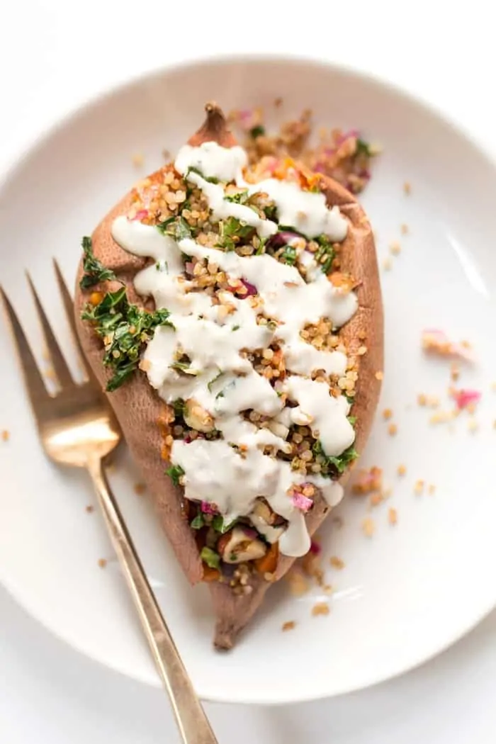 quinoa stuffed sweet potatoes with tahini and kale