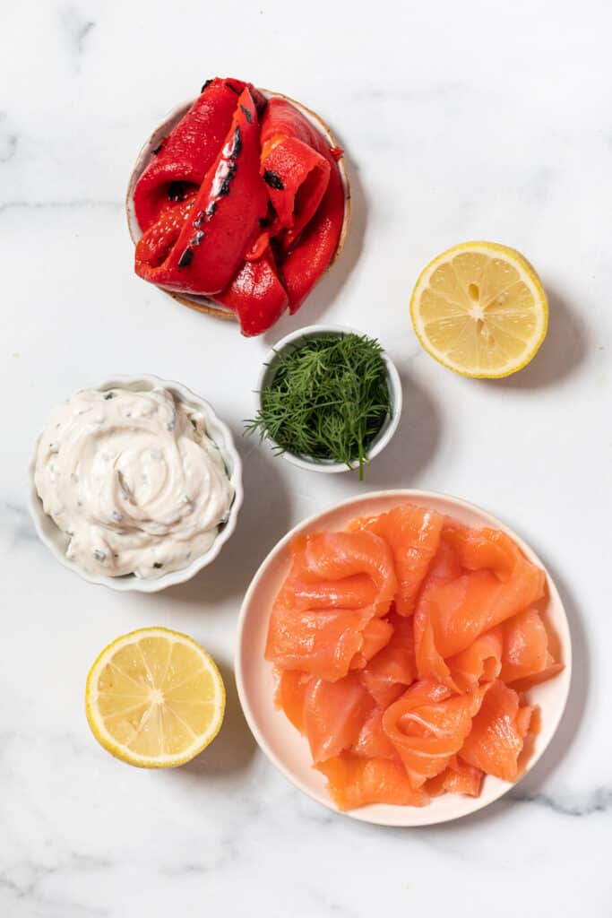 An easy smoked salmon spread flavored with roasted red peppers, fresh lemon, and dill. Serve as a dip with crackers or as a sandwich spread. Ingredients for smoked salmon spread with roasted red peppers.