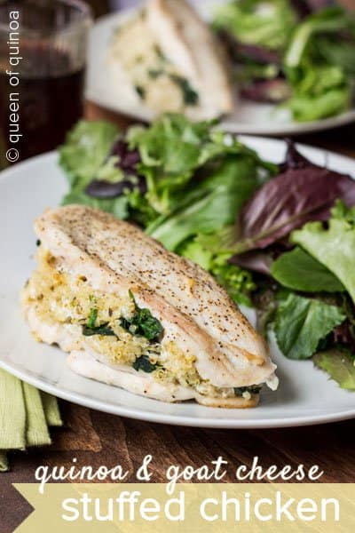 Quinoa and goat cheese stuffed chicken on a plate with salad.