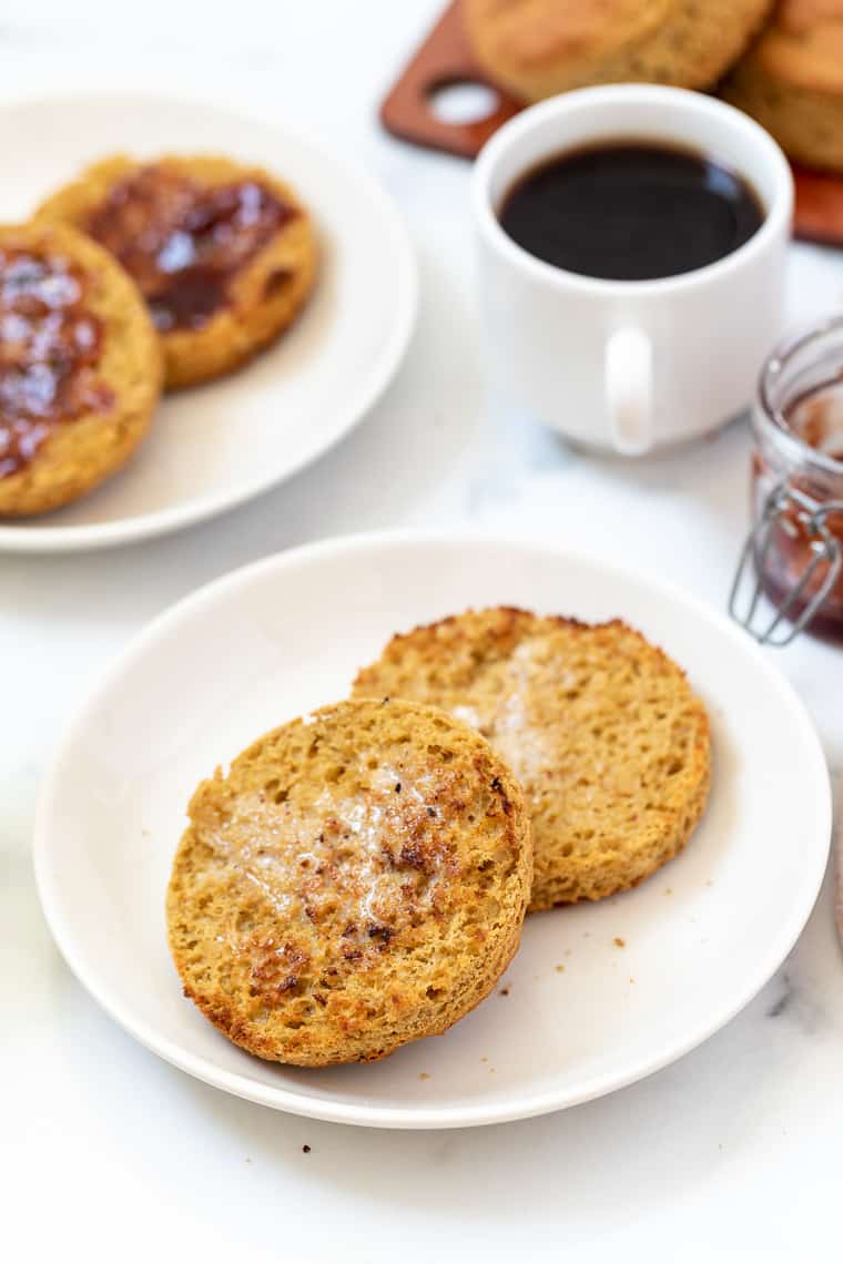 The best homemade gluten-free English muffins! They're fluffy, light, tender and so delicious when toasted. A reader favorite! Plate with toasted and buttered gluten-free English muffin