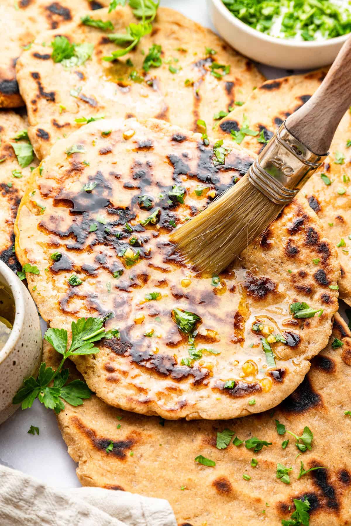 Brushing ghee onto gluten-free naan