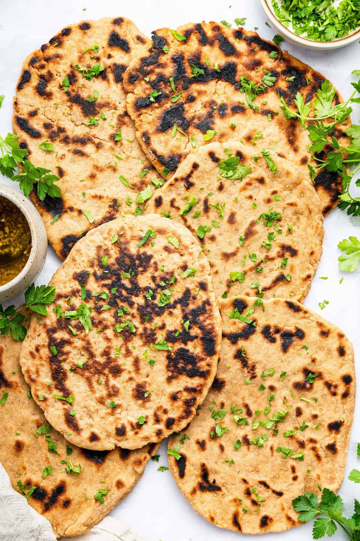 Overhead view of gluten-free naan piled onto countertop