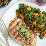 Grilled pork chop on a plate with red quinoa salad.