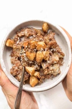 cinnamon apple breakfast quinoa recipe with apples and coconut on top