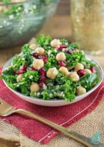 Kale, pomegranate, and quinoa salad on a plate.