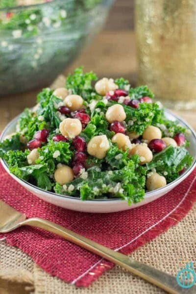 Kale, pomegranate, and quinoa salad on a plate.