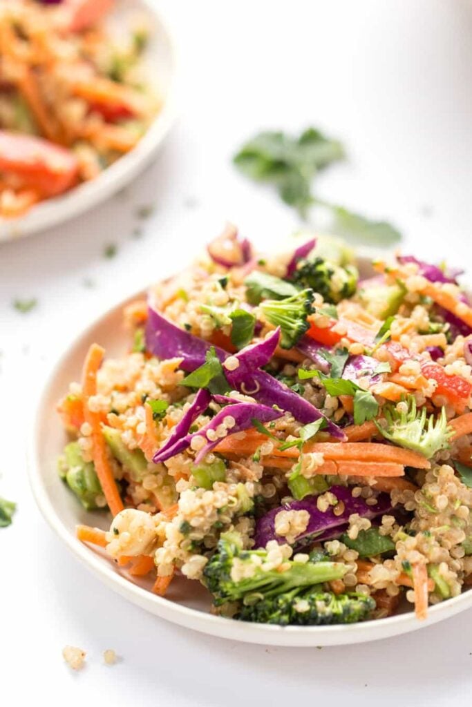 Bowl of Thai quinoa salad with veggies and almond butter dressing