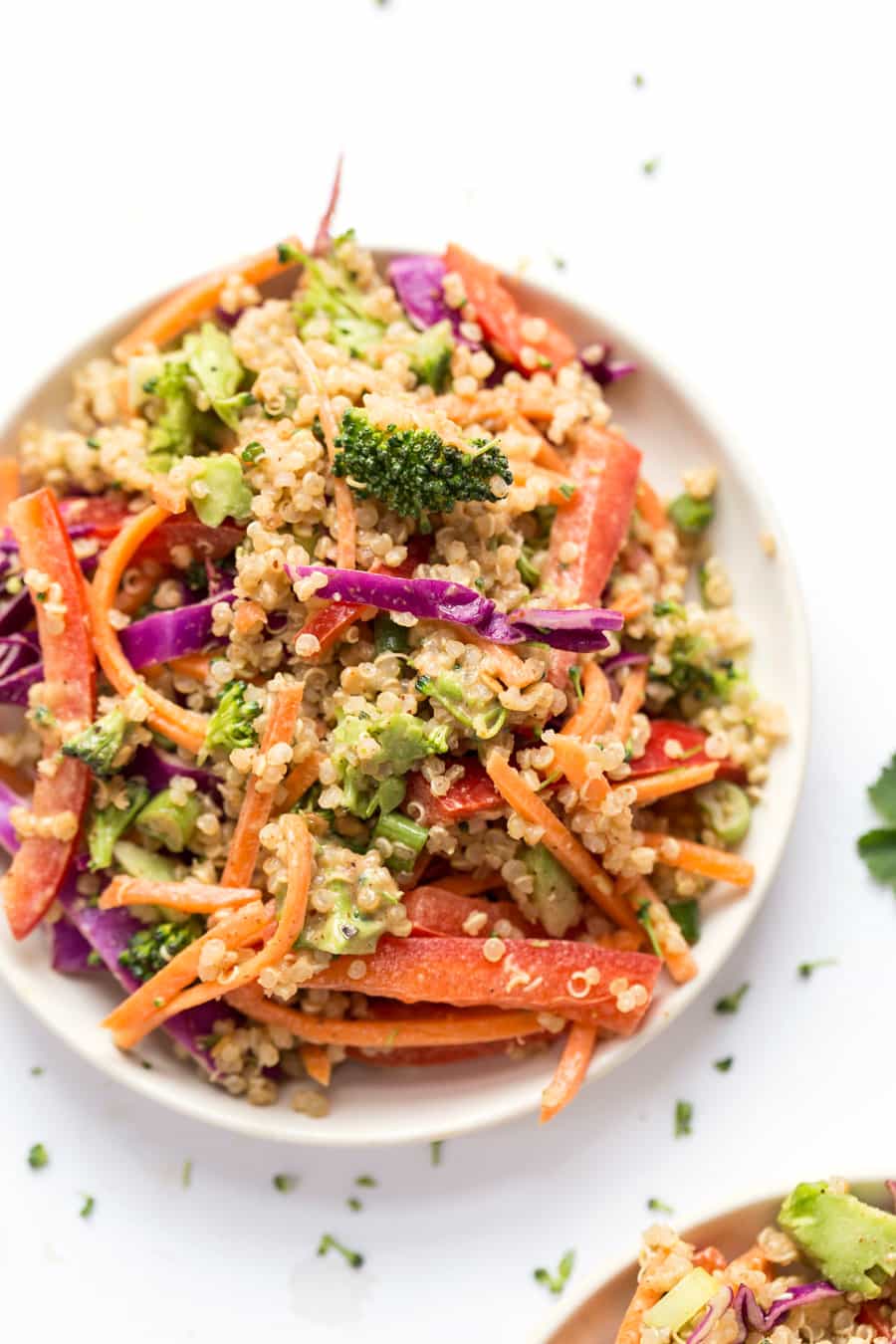 This simple THAI QUINOA SALAD is peppered with a rainbow of veggies and tossed in a creamy almond butter sauce! Tastes like pad thai, but in salad form!