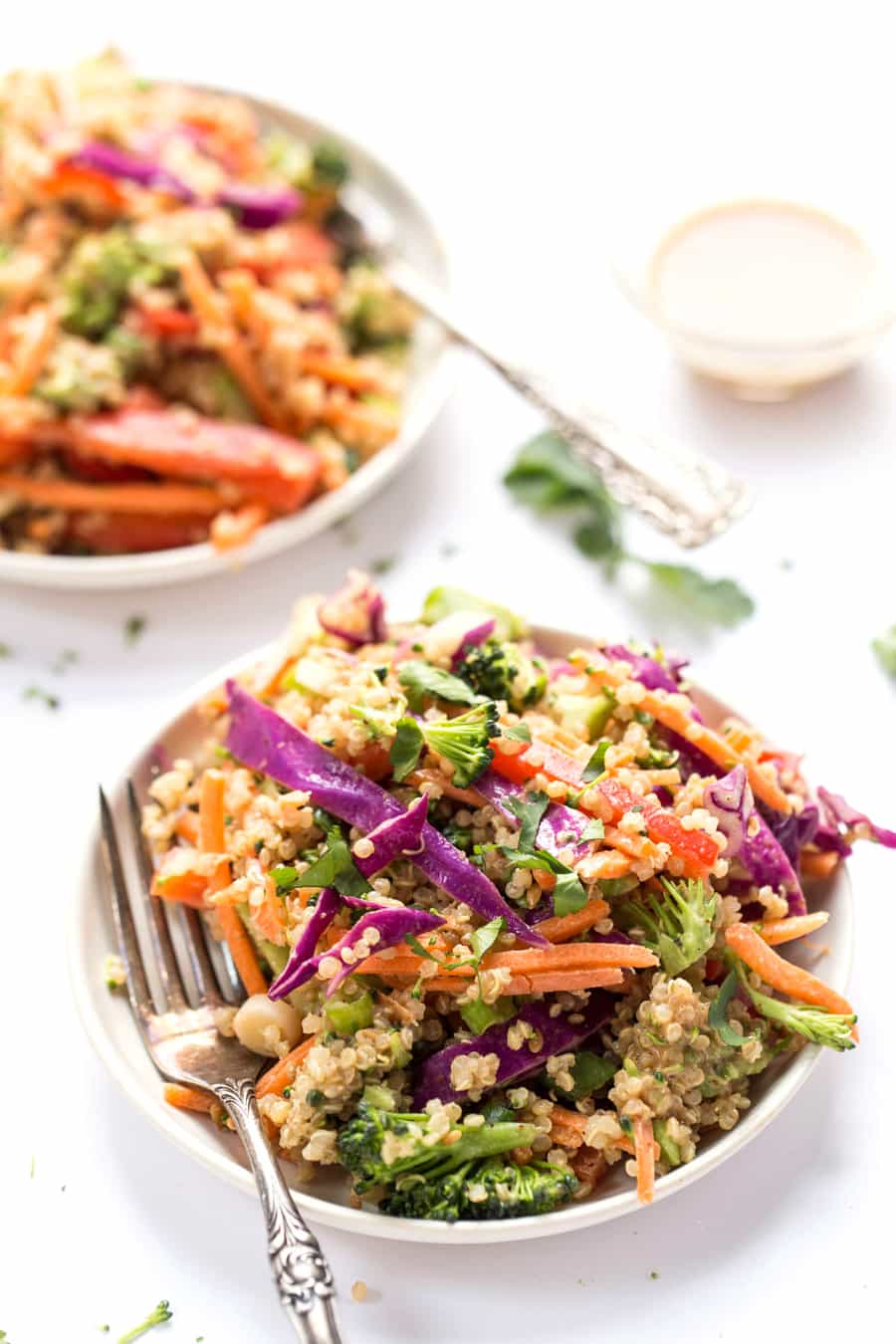 This simple THAI QUINOA SALAD is peppered with a rainbow of veggies and tossed in a creamy almond butter sauce! Tastes like pad thai, but in salad form!