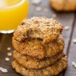 Stack of Toasted Coconut Quinoa Breakfast Cookies next to a glass of orange juice.