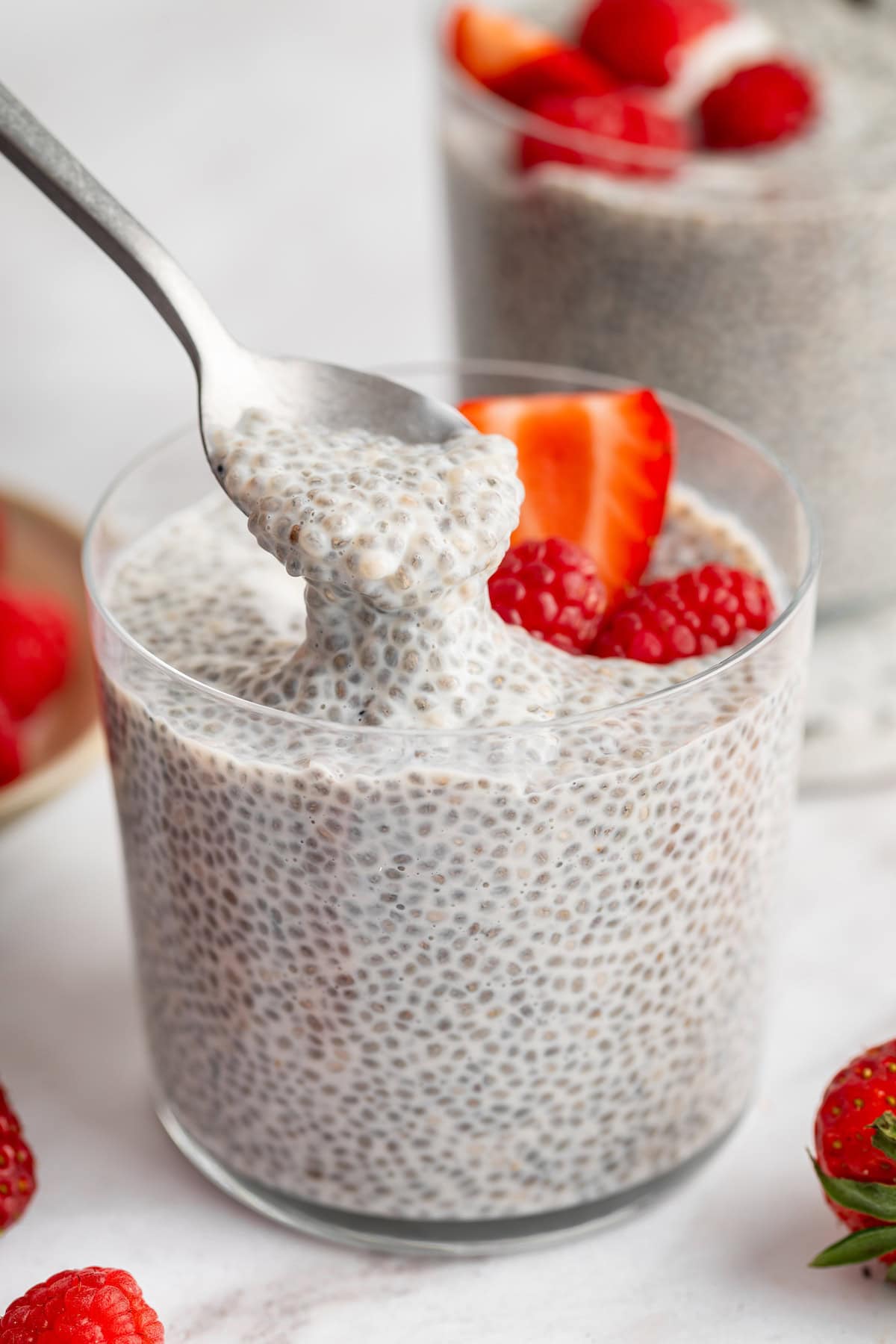 Spoonful of vanilla chia pudding being lifted from cup.