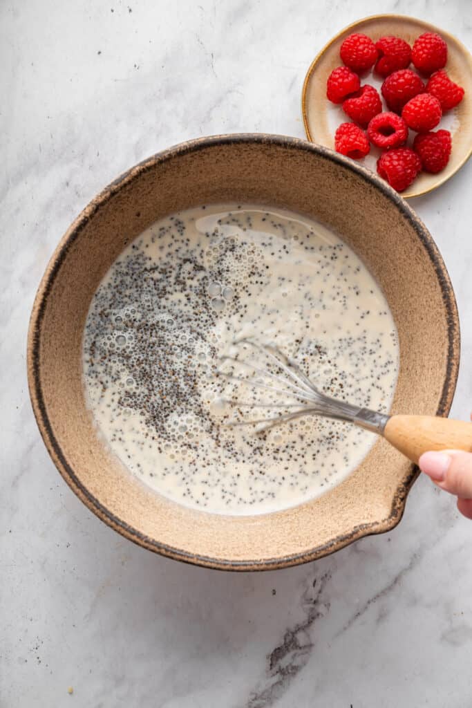 This vanilla chia pudding makes the perfect breakfast, but it tastes like dessert! It's easy to make and so delicious. Whisking chia seeds into milk mixture.