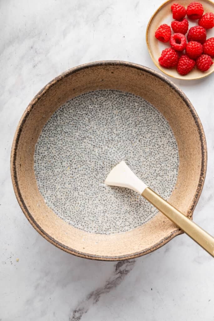 This vanilla chia pudding makes the perfect breakfast, but it tastes like dessert! It's easy to make and so delicious. Stirring vanilla chia pudding in bowl.