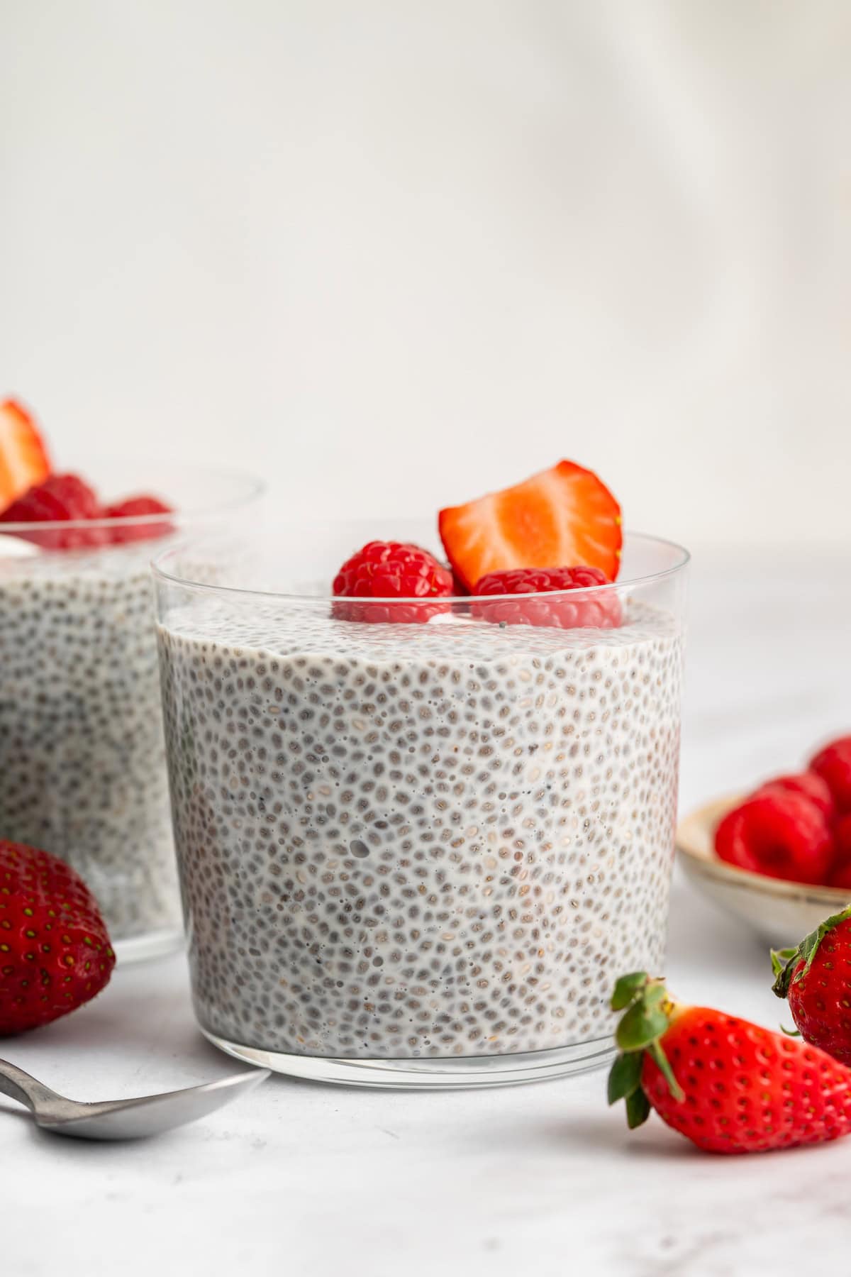 Vegan vanilla chia pudding in cup with fresh berries.