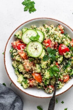 overhead of white bowl with quinoa tabbouleh salad on top