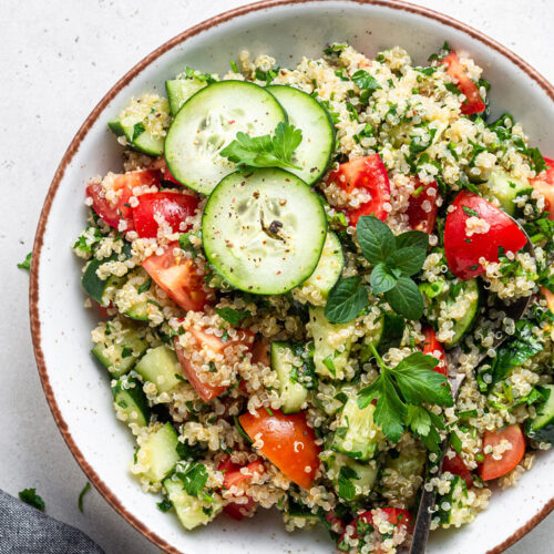overhead of white bowl with quinoa tabbouleh salad on top
