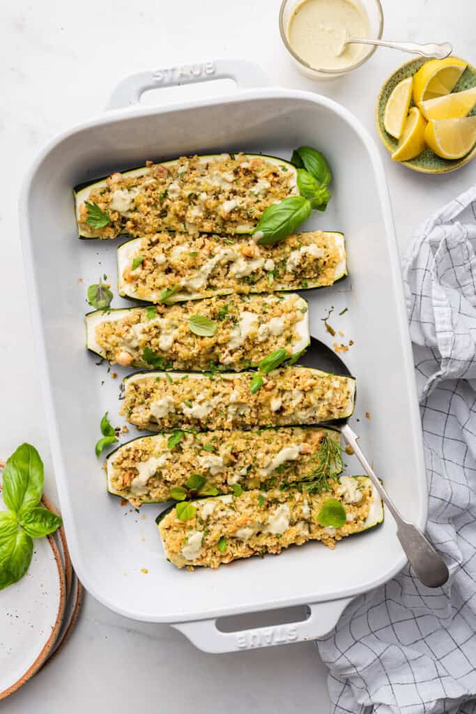 Overhead view of stuffed zucchini boats in casserole dish
