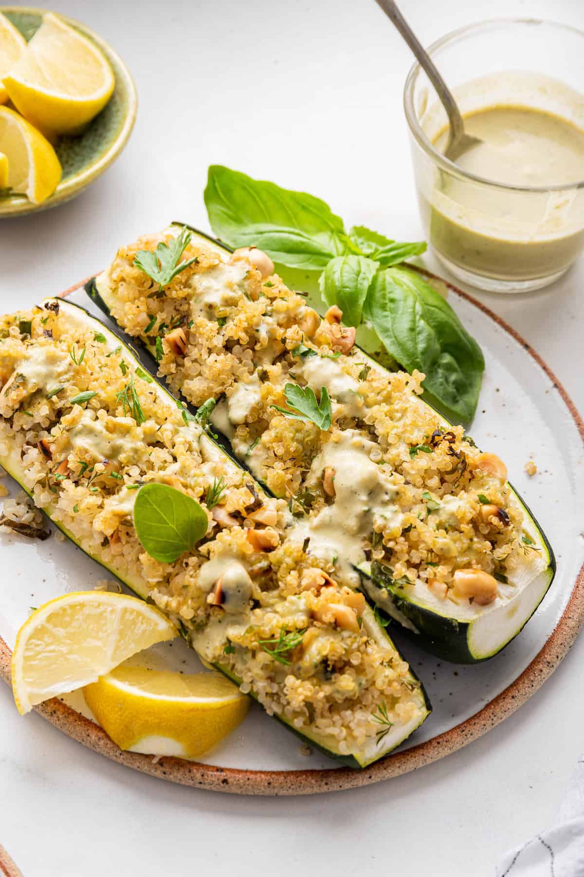 Two quinoa stuffed zucchini boats on plate