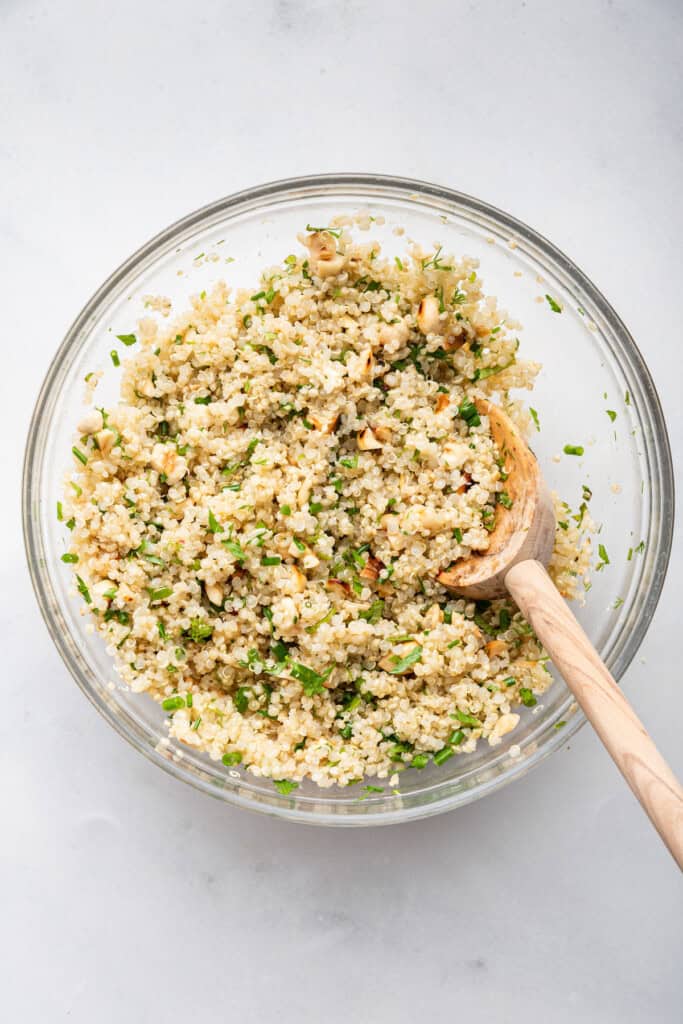 Overhead view of quinoa filling in glass mixing bowl