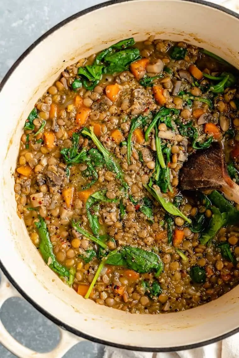 healthy lentil recipe in a big pot cooking with spinach