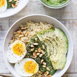 Savory Pesto Quinoa Breakfast Bowls topped with a soft boiled egg, sliced avocado and toasted pine nuts -- PLUS check out these other amazing quinoa bowl recipes!