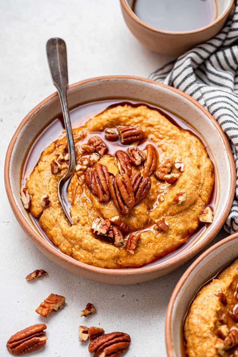 bowl of pumpkin quinoa with nuts on top