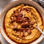 bowl of pumpkin breakfast quinoa with pecans