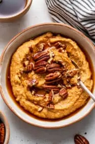 bowl of pumpkin breakfast quinoa with pecans