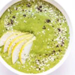 Caramel Cashew Green Smoothie bowl topped with sliced pears, hemp seeds, quinoa flakes and vanilla powder -- it tastes like you're eating a bowl of ice cream for breakfast, but it's actually good for you!