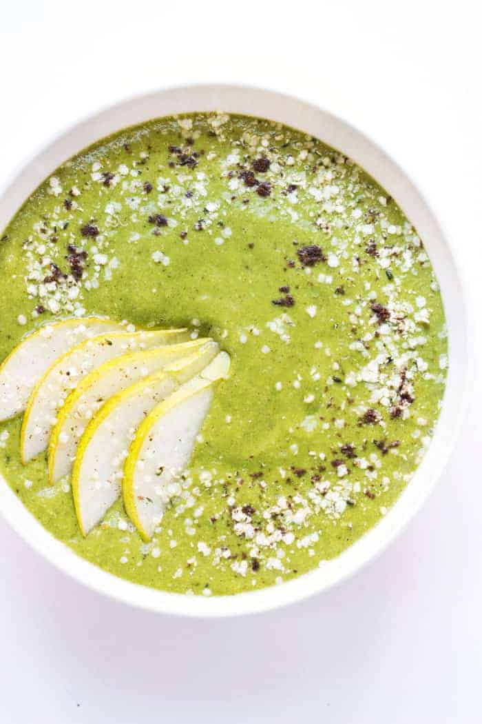 Caramel Cashew Green Smoothie bowl topped with sliced pears, hemp seeds, quinoa flakes and vanilla powder -- it tastes like you're eating a bowl of ice cream for breakfast, but it's actually good for you!