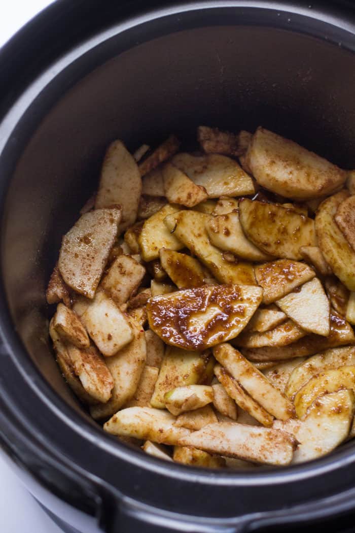 How to make apple crisp in the slow cooker. You start with just four simple ingredients: apples, coconut sugar, cinnamon and lemon juice.