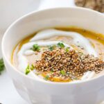 Vegan Gingered Carrot Bisque from the new Food52 Cookbook - topped with a heaping serving of crispy garlic quinoa