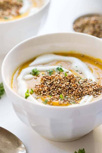 Vegan Gingered Carrot Bisque from the new Food52 Cookbook - topped with a heaping serving of crispy garlic quinoa