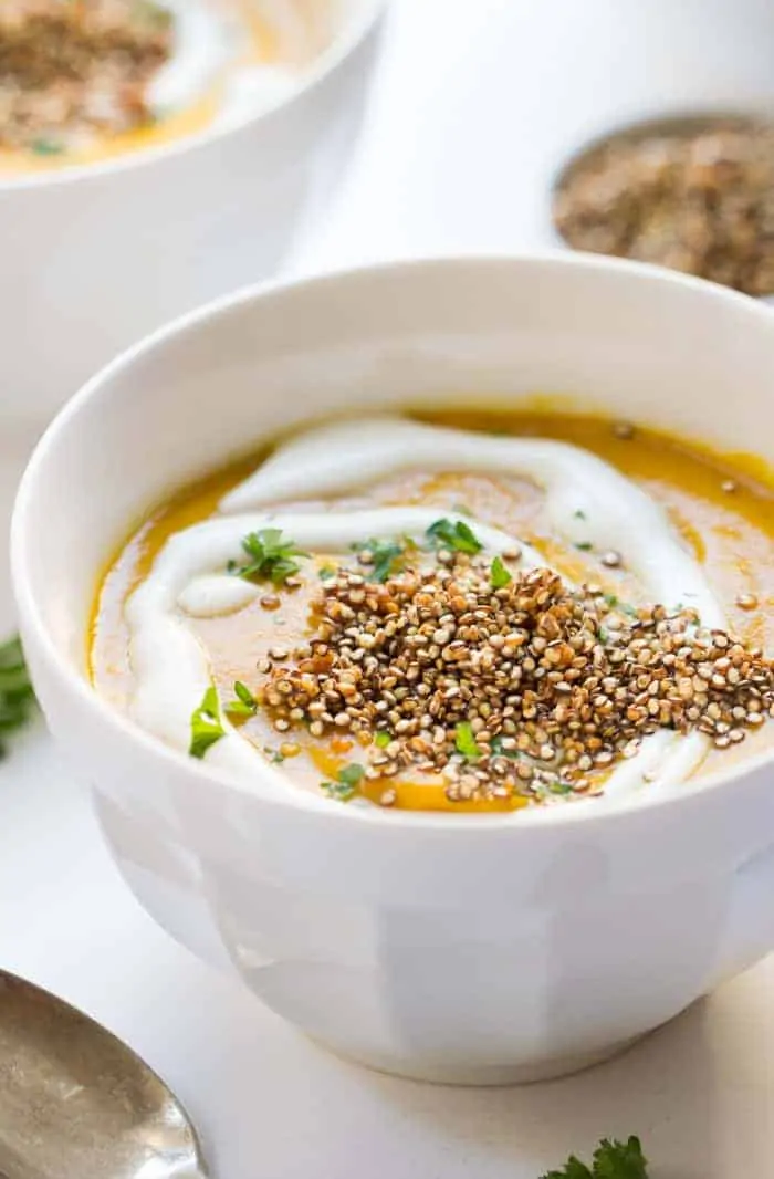 Vegan Gingered Carrot Bisque from the new Food52 Cookbook - topped with a heaping serving of crispy garlic quinoa